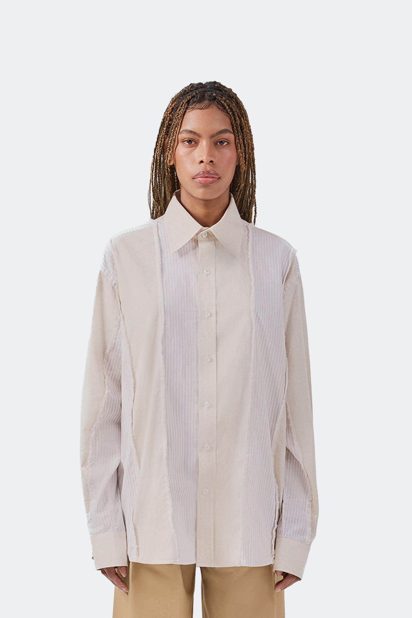 Front detail of the Salango Striped Shirt in Sand crafted from lightweight 100% cotton with tonal striped panels, exposed raw-edge detailing, classic point collar, and relaxed fit.