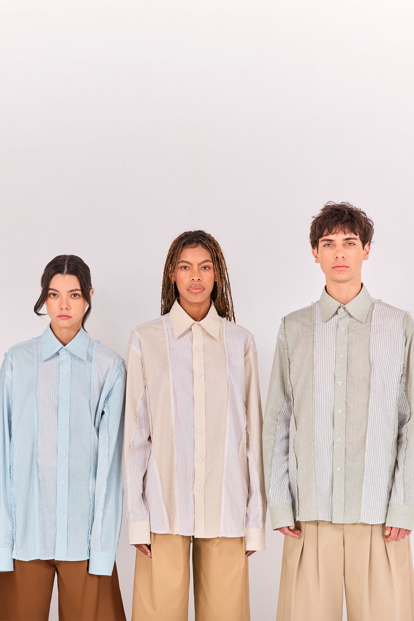 Models wearing the Salango Striped Shirt in Sky, Sand, and Baby Moss, showcasing deconstructed striped panels, raw-edge detailing, and relaxed tailoring from the Ethereal SS26 collection.