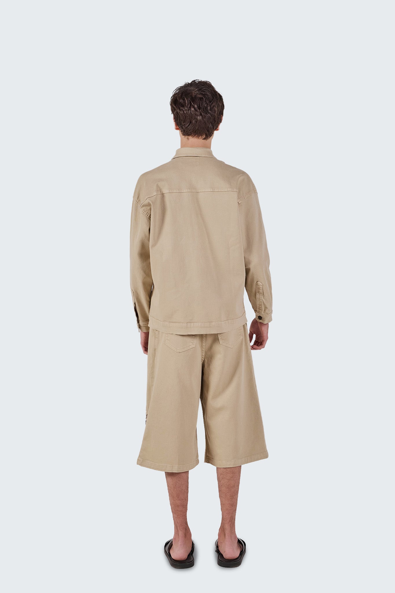 Back view of the Salango Workman Jacket in sand cotton with clean utility-inspired construction and relaxed fit.