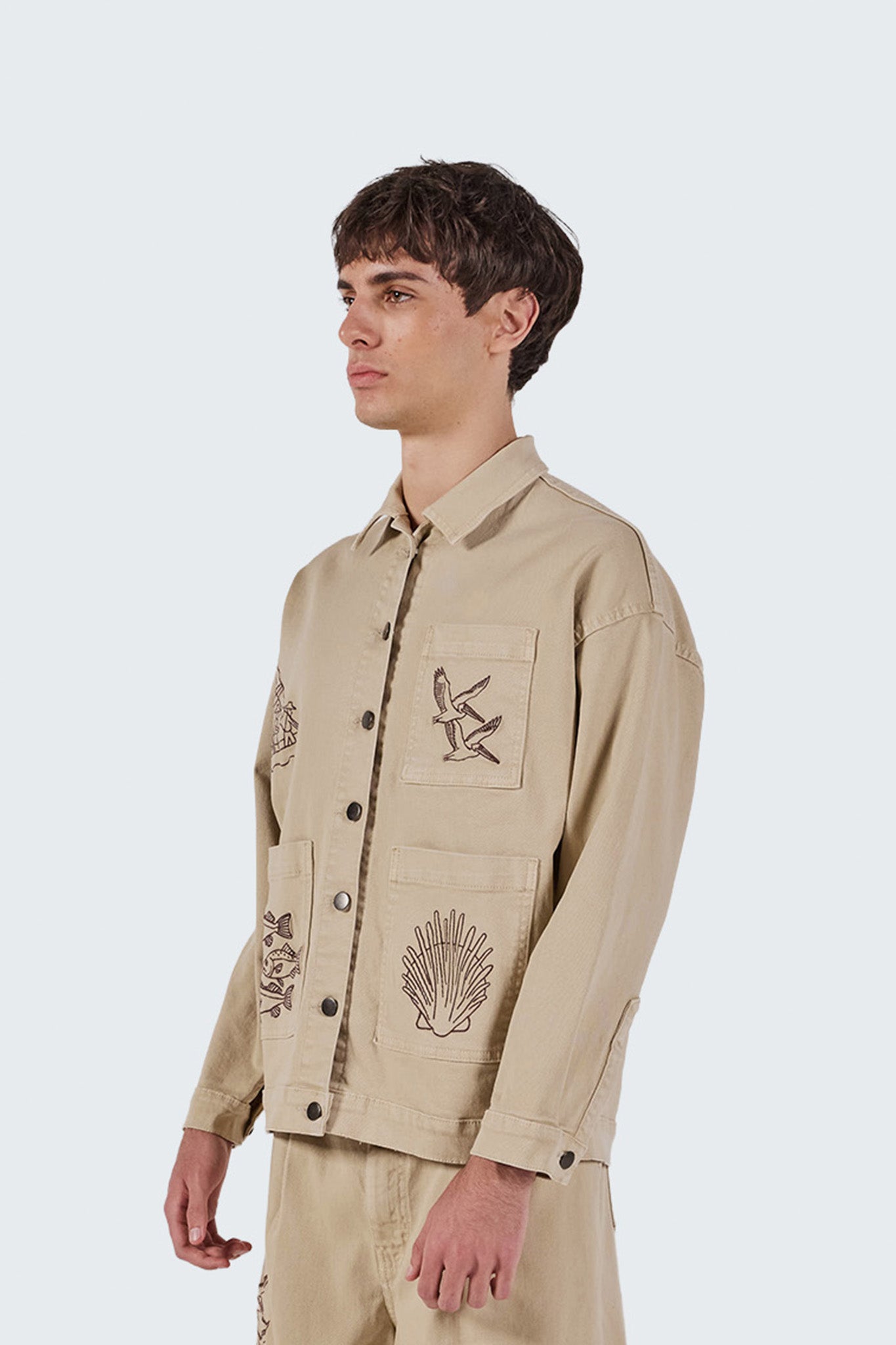 Side profile of the Salango Workman Jacket highlighting its relaxed workwear silhouette and soft cotton fabric.