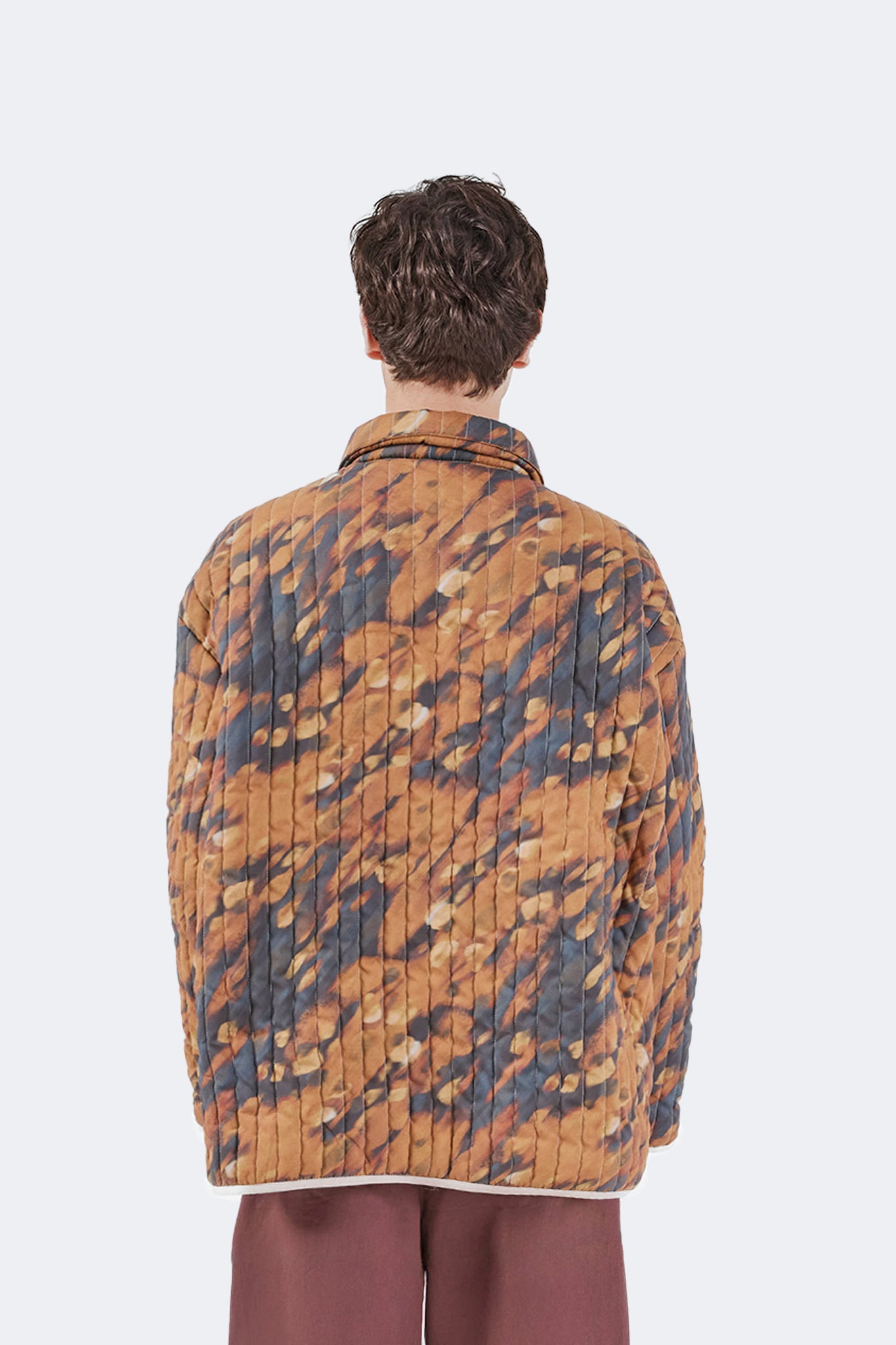 Front detail of the Same Quilted Jacket featuring the exclusive Same print, button-front closure, oversized patch pockets, and contrast binding.