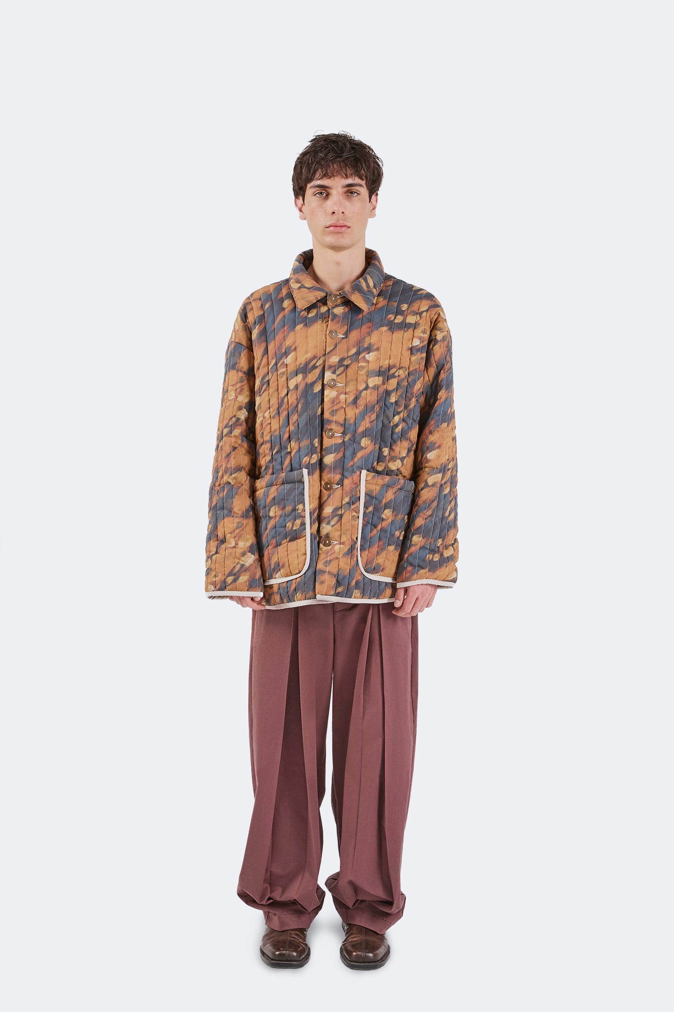 Full front view of the Same Quilted Jacket showcasing the relaxed fit, quilted cotton construction, oversized utility pockets, and exclusive artistic print.