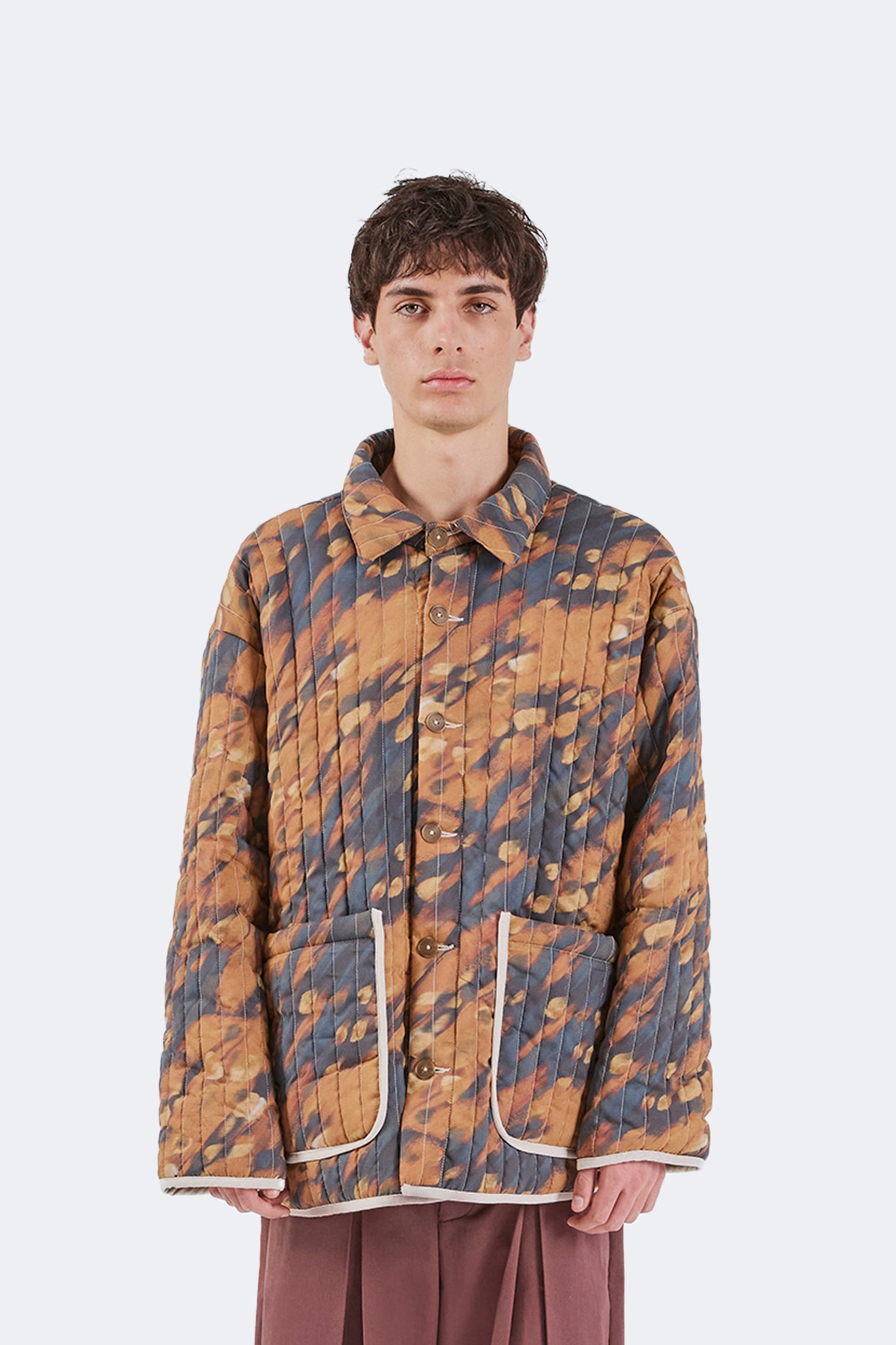 Front detail of the Same Quilted Jacket featuring the exclusive Same print, button-front closure, oversized patch pockets, and contrast binding.