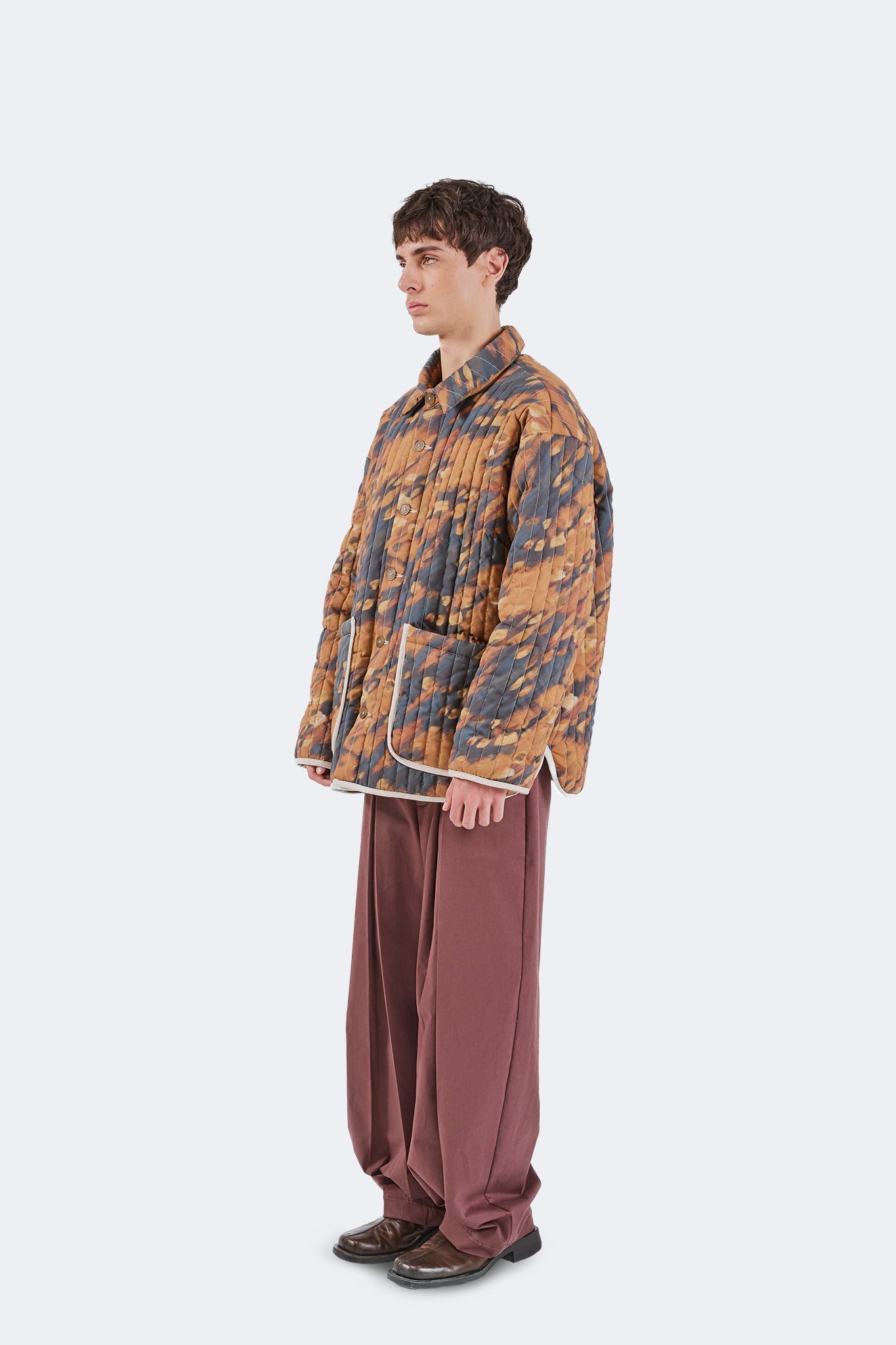 Side view of the Same Quilted Jacket featuring the lightweight quilted construction, relaxed fit, and exclusive Same print.