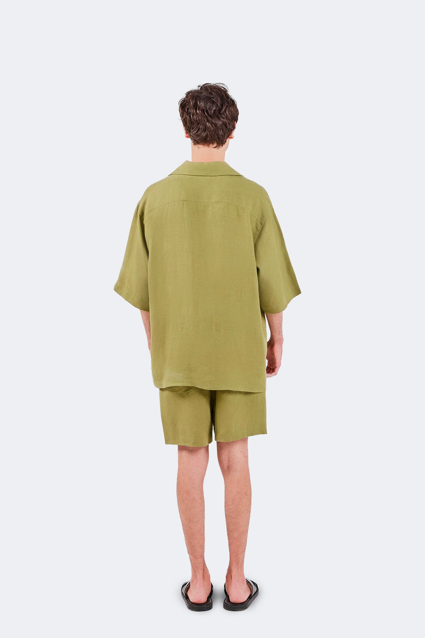 Back view of the San Cristobal Short-Sleeved Shirt in Moss with relaxed tailoring and lightweight linen drape.