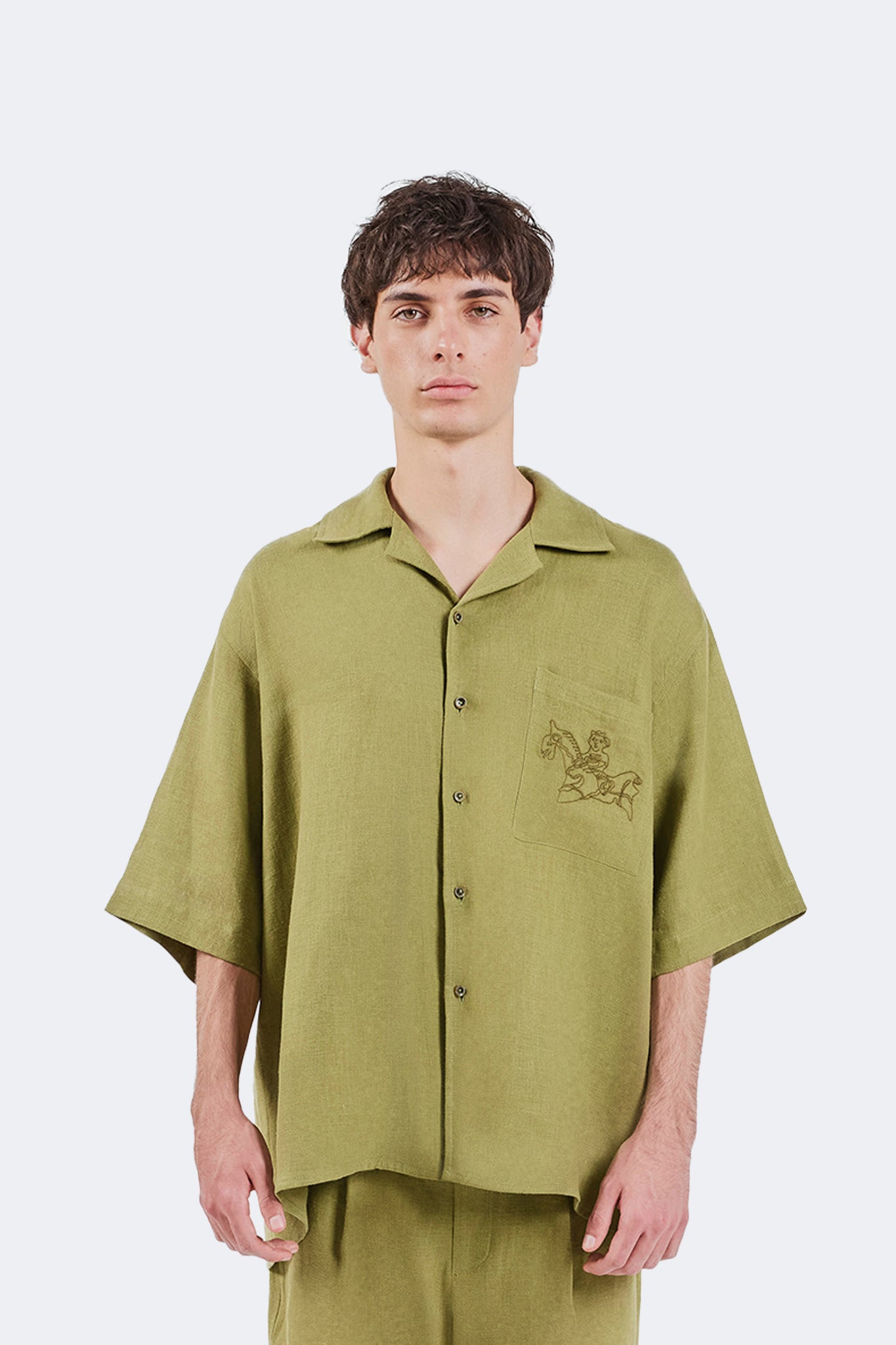 Portrait view of the San Cristobal Short-Sleeved Shirt featuring an oversized silhouette, camp collar, and Moss linen fabrication.