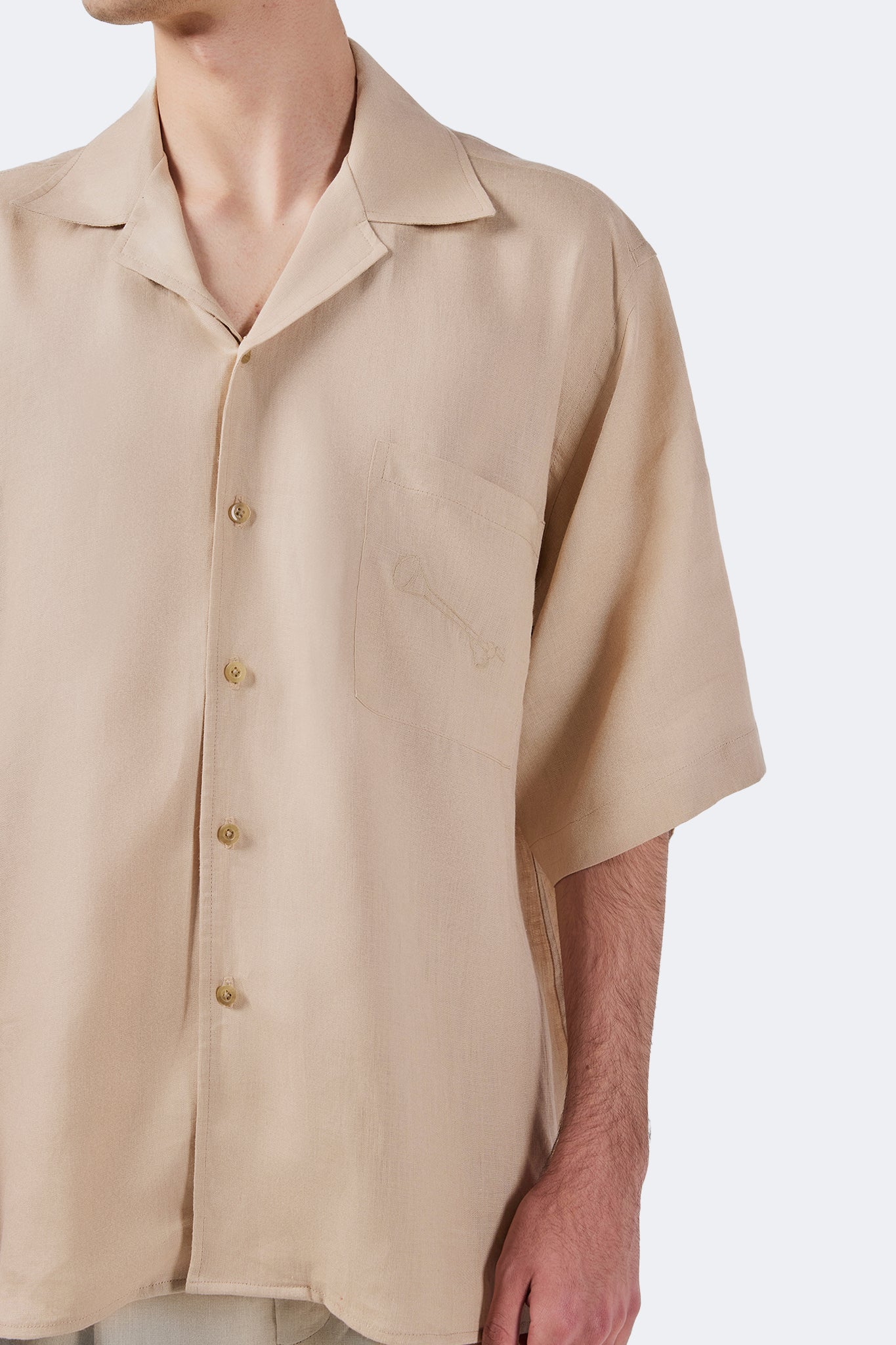 Side detail of the Santa Cruz Short-Sleeved Shirt Ivory highlighting its natural drape and lightweight linen construction.