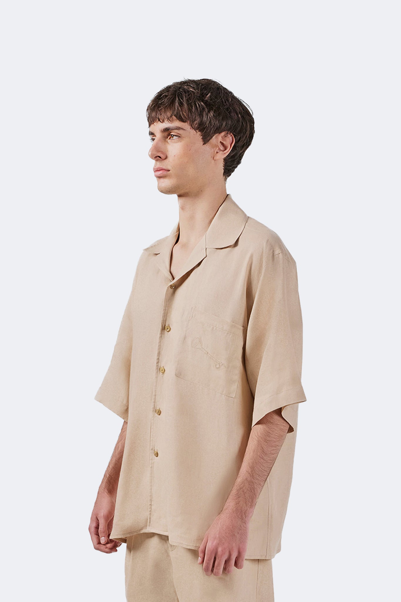 Side detail of the Santa Cruz Short-Sleeved Shirt Ivory highlighting its natural drape and lightweight linen construction.