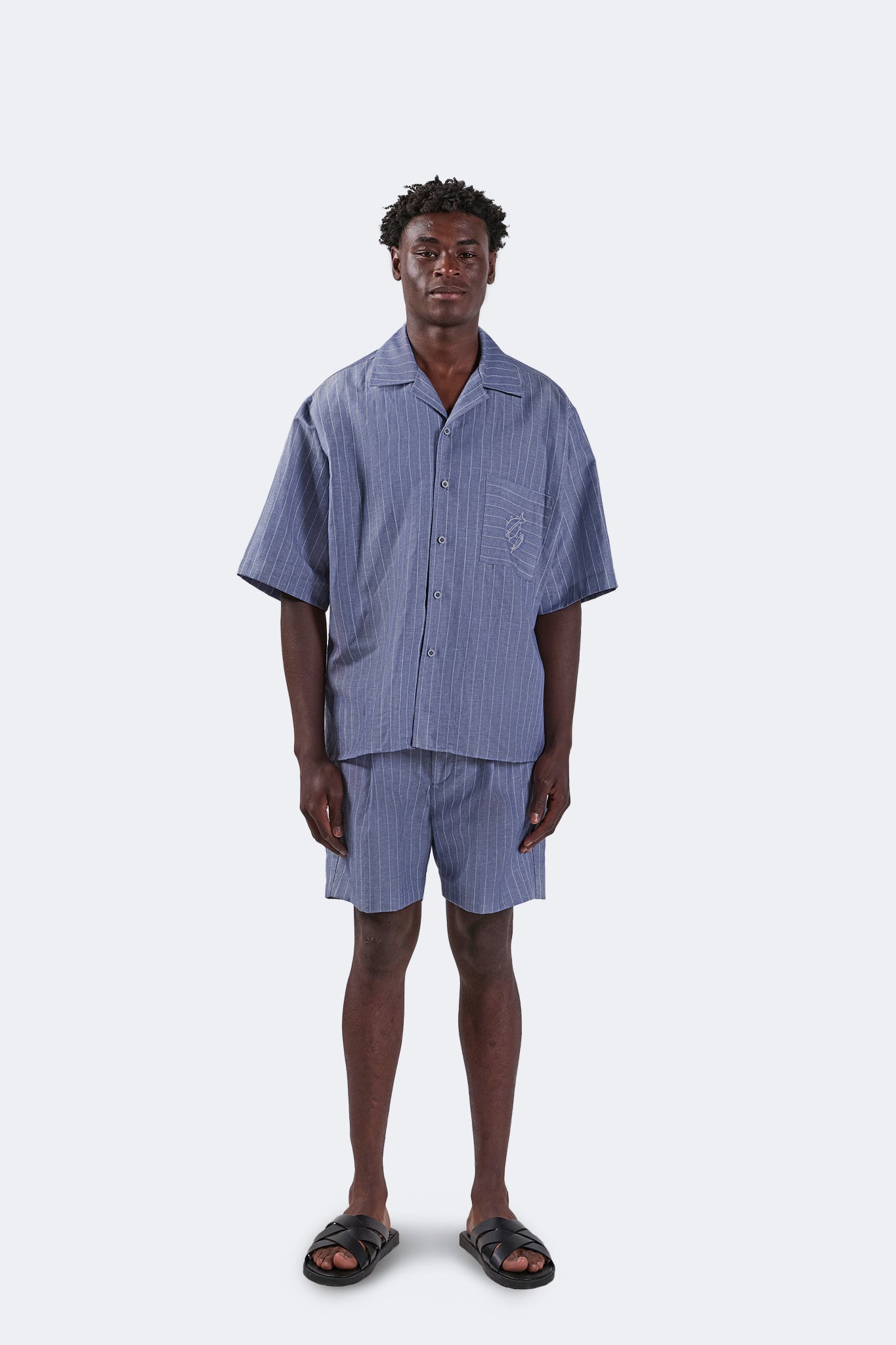 Full front view of the Santa Cruz Short-Sleeved Shirt in Indigo Pinstripe styled with coordinating linen shorts, featuring a relaxed oversized silhouette and camp collar.
