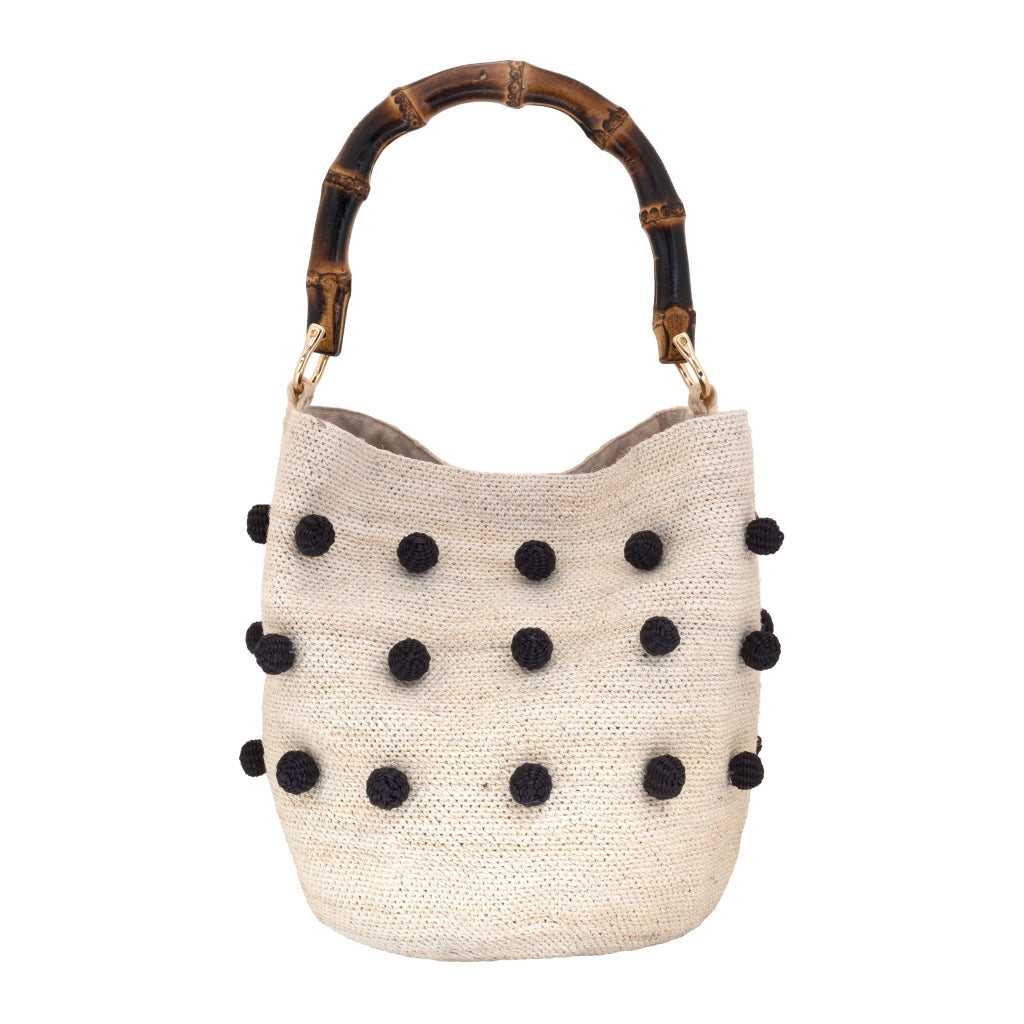 Handwoven toquilla straw shigra bag with black crochet beads made by women in Ecuador’s Central and Northern Andes, with a bamboo handle by Olga Fisch.