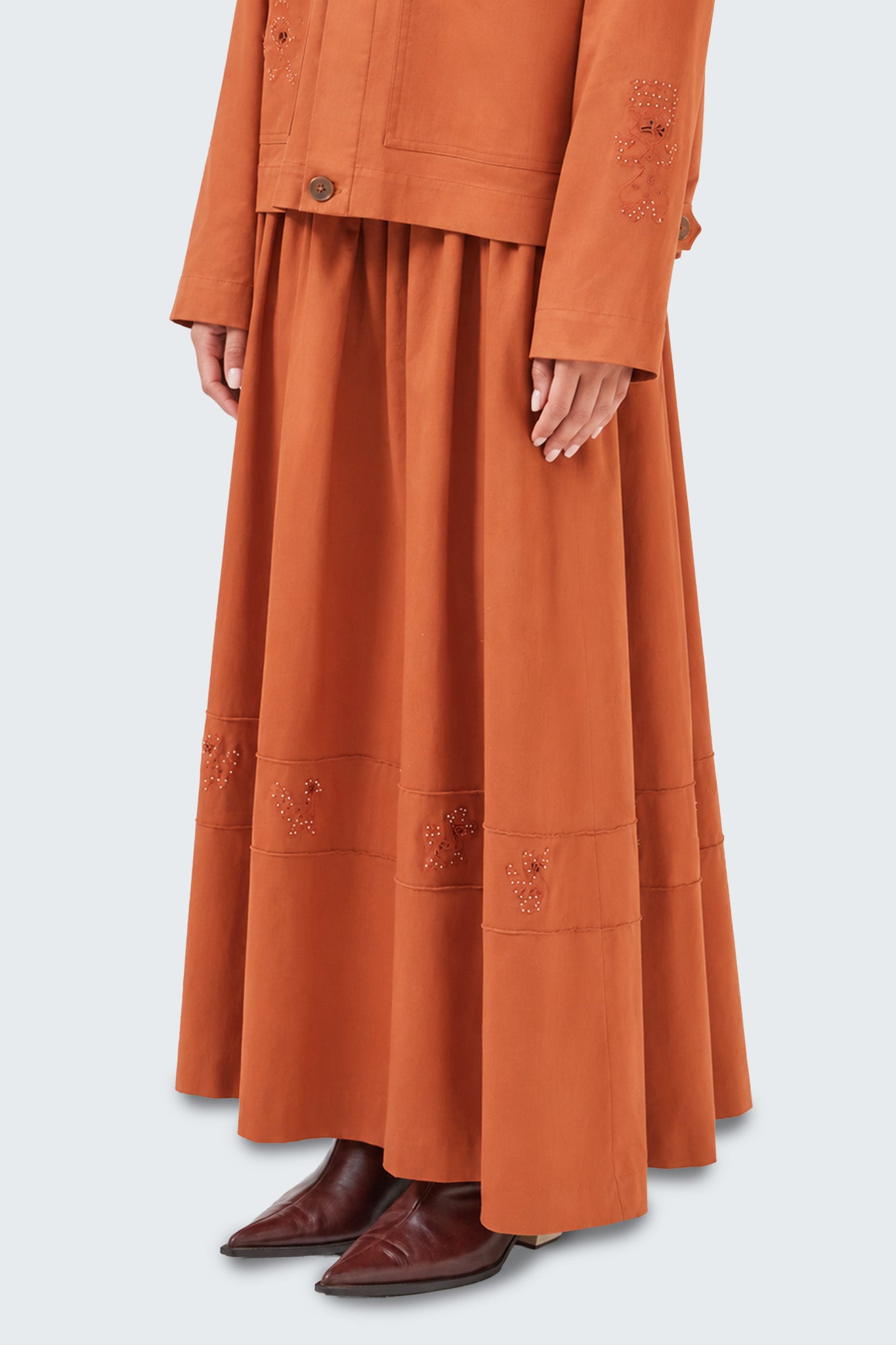 Close-up side view of the Tolita skirt highlighting gathered volume, embroidered motifs, and elegant drape.