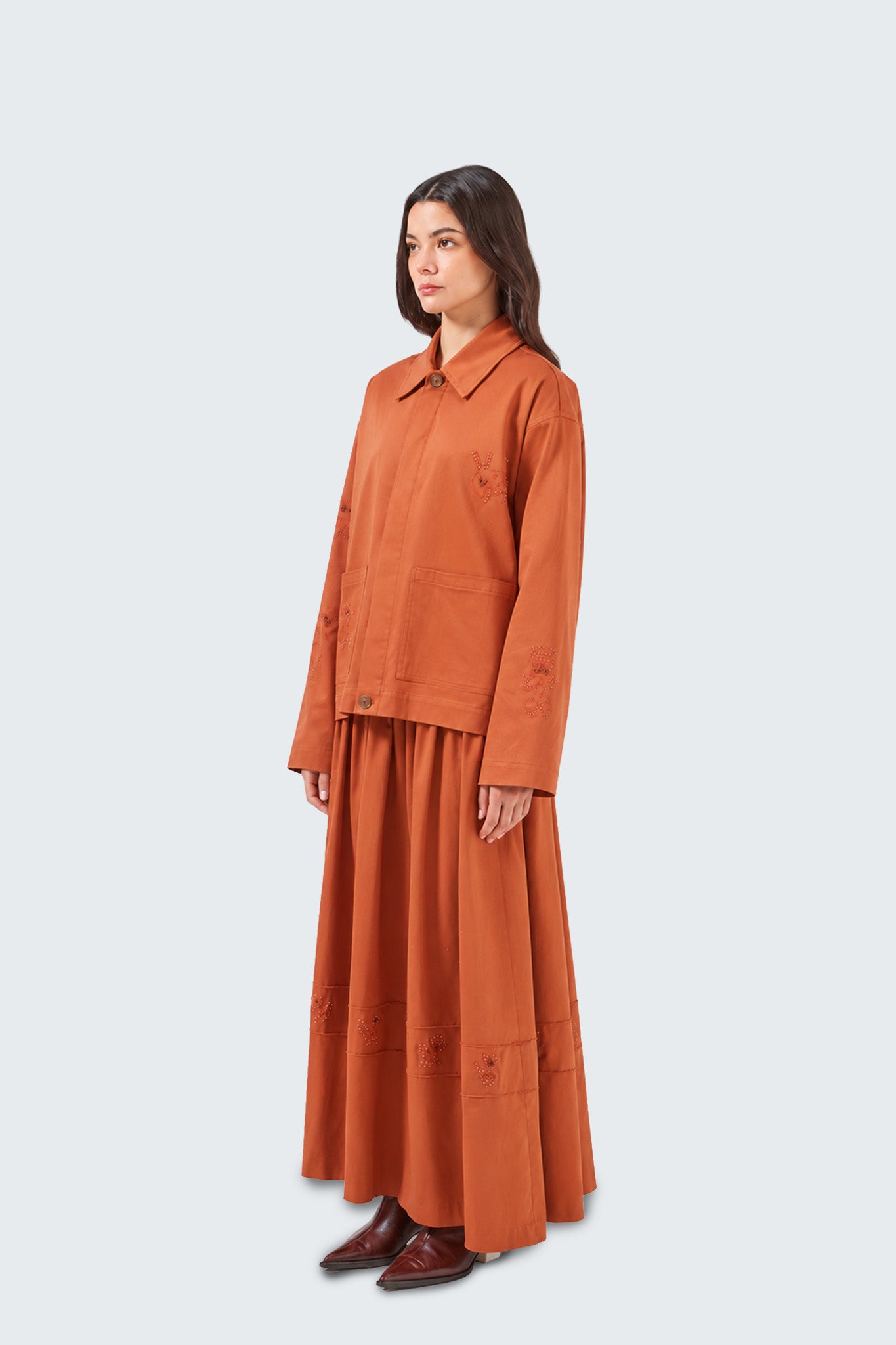 Woman wearing an orange outfit on a white background