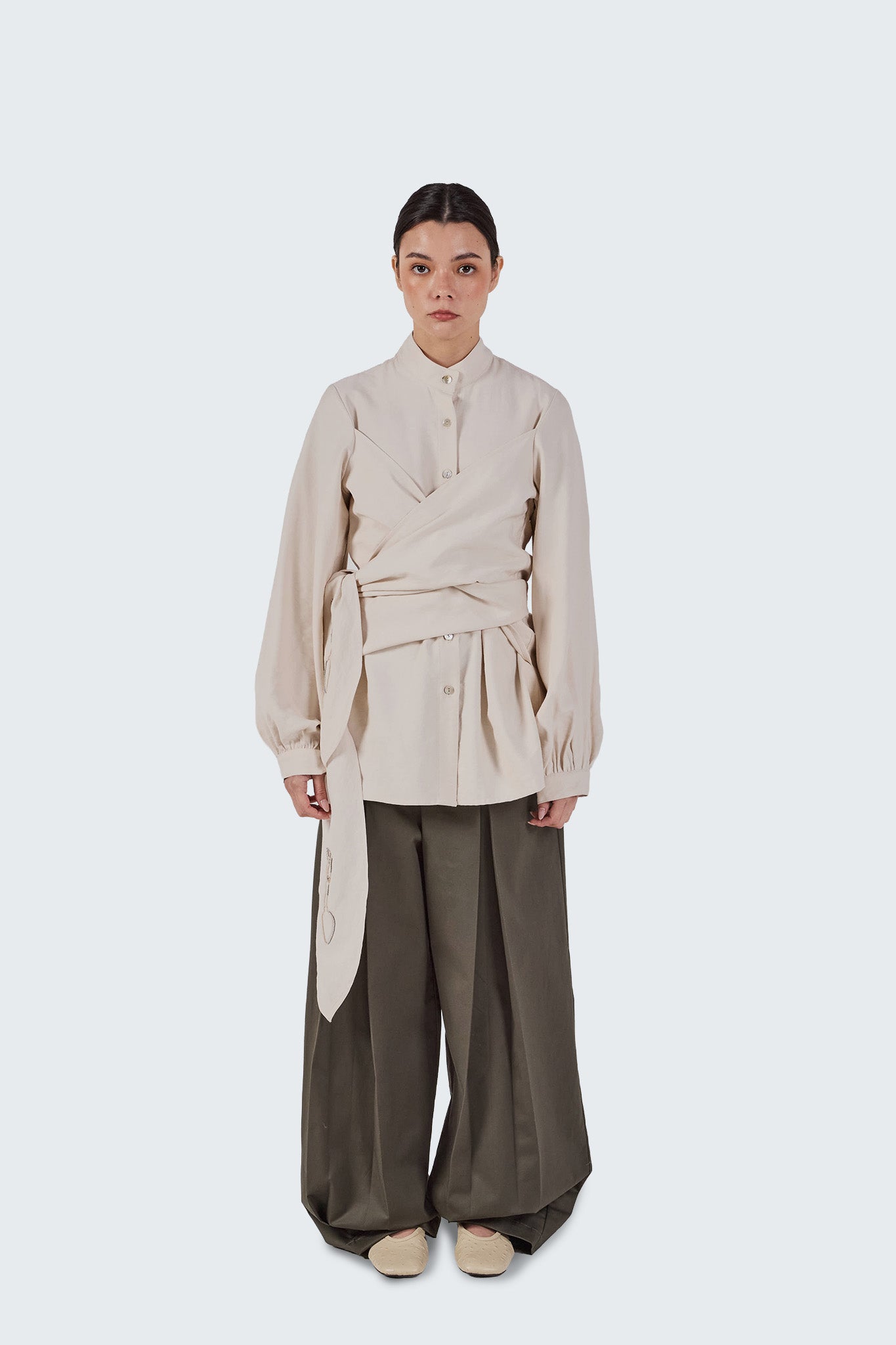 Front view of the Zigze Knotted Blouse in Off-White featuring a wrap-front design, self-tie waist detail, and gathered sleeves.