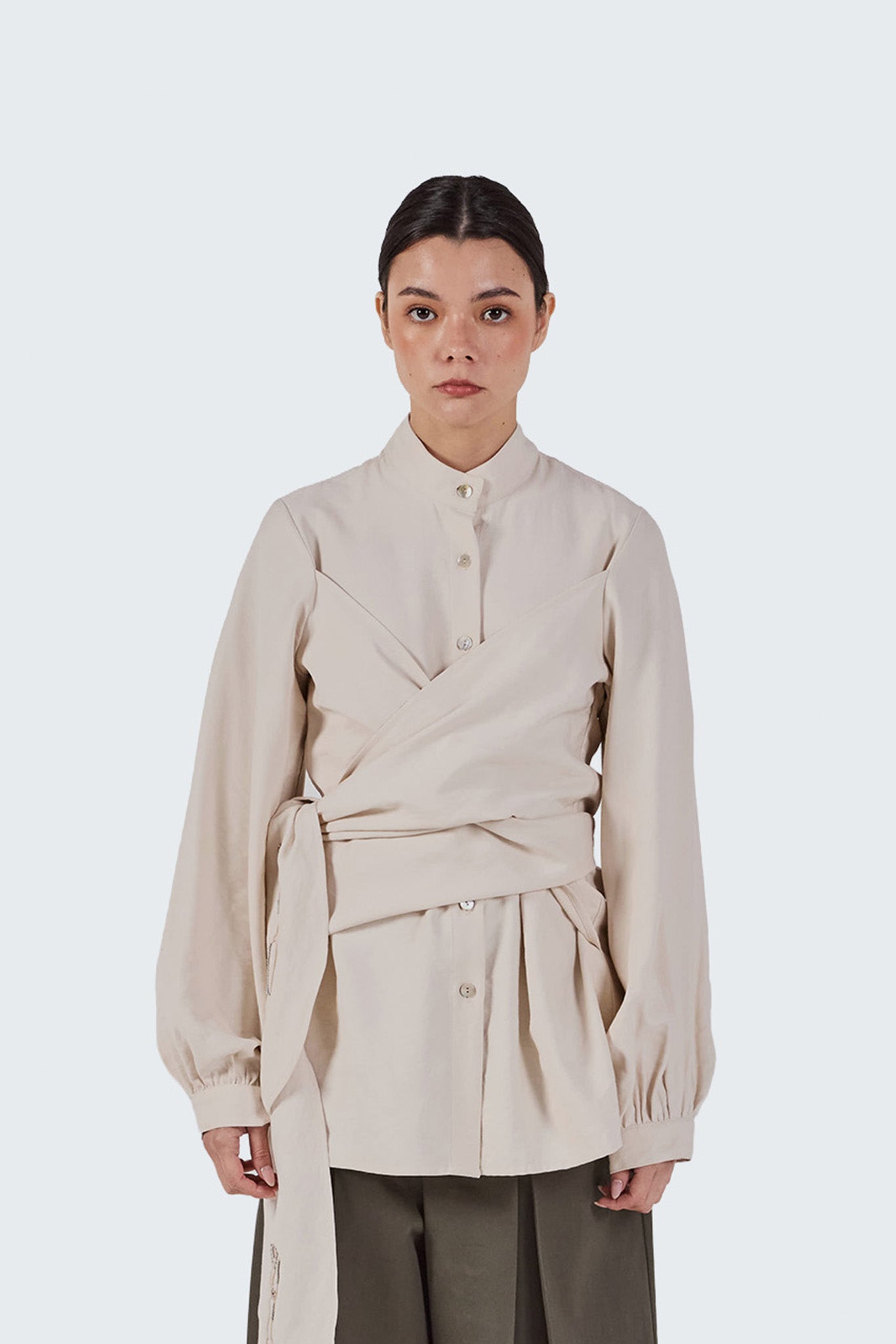Close-up front detail of the Zigze Knotted Blouse highlighting the stand collar, button-front construction, and architectural wrap styling.