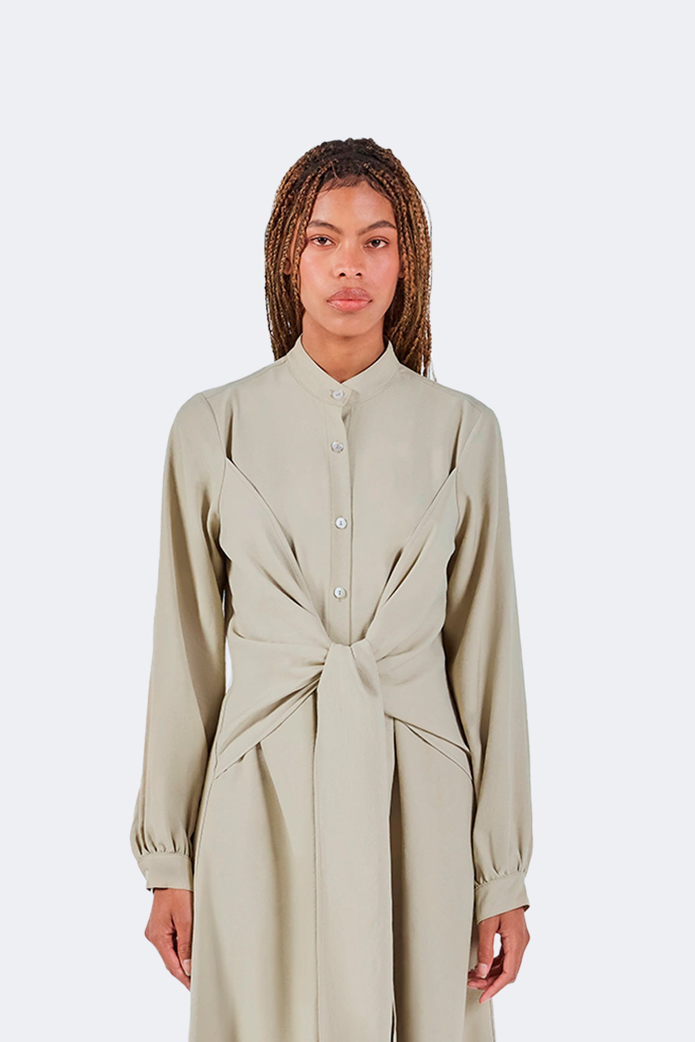 Front detail of the Zigze Knotted Dress in Baby Moss highlighting the stand collar, concealed button placket, and sculptural knotted waist design.