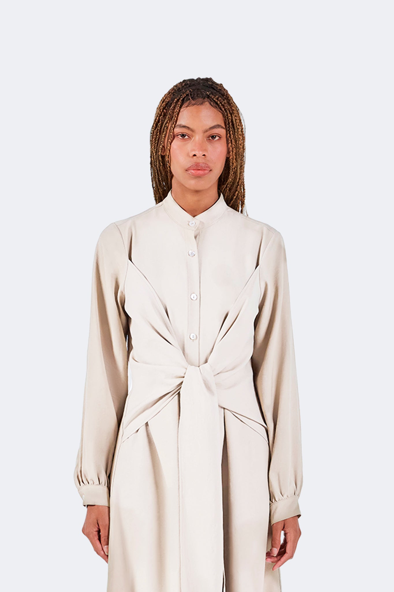 Front detail of the Zigze Knotted Dress in Ivory highlighting the stand collar, concealed button placket, and sculptural knotted waist design.